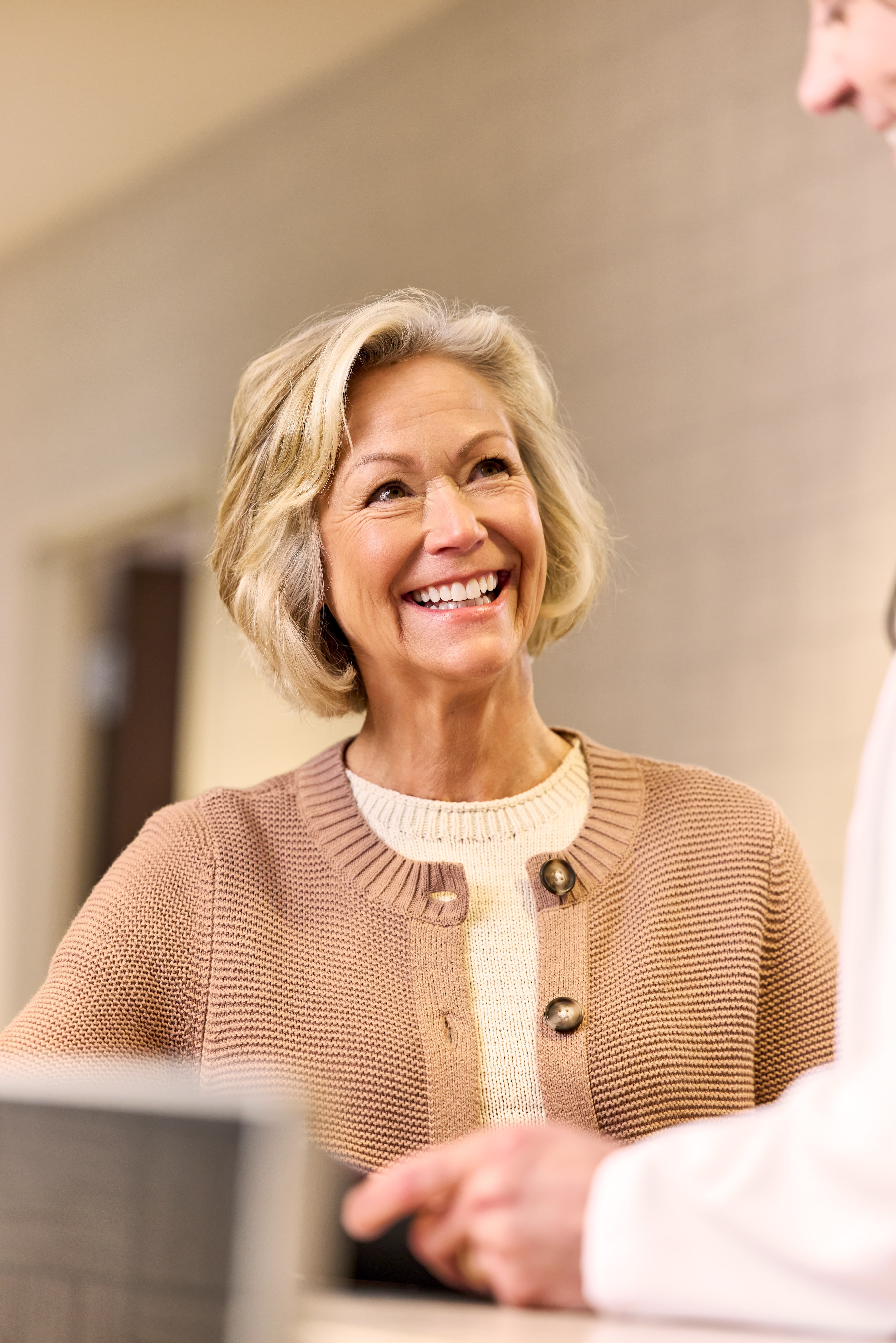 20-join-us-practices-stay-local-smiling-patient-2026 03 Qualderm BR Hallway 1281 (1)