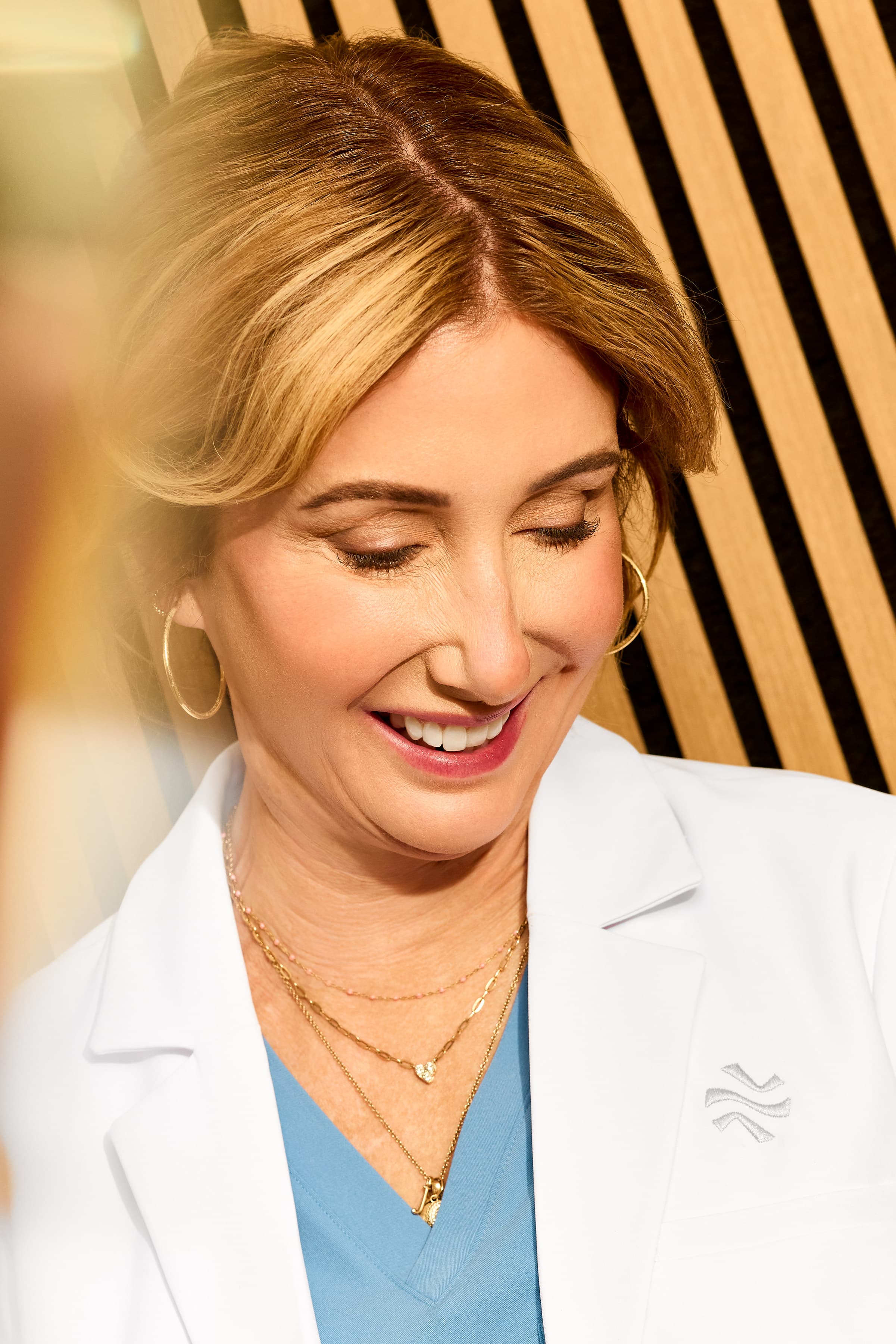 19-join-us-clinical-leadership-smiling-doctor-2026 03 Qualderm BR Exam Room 3702